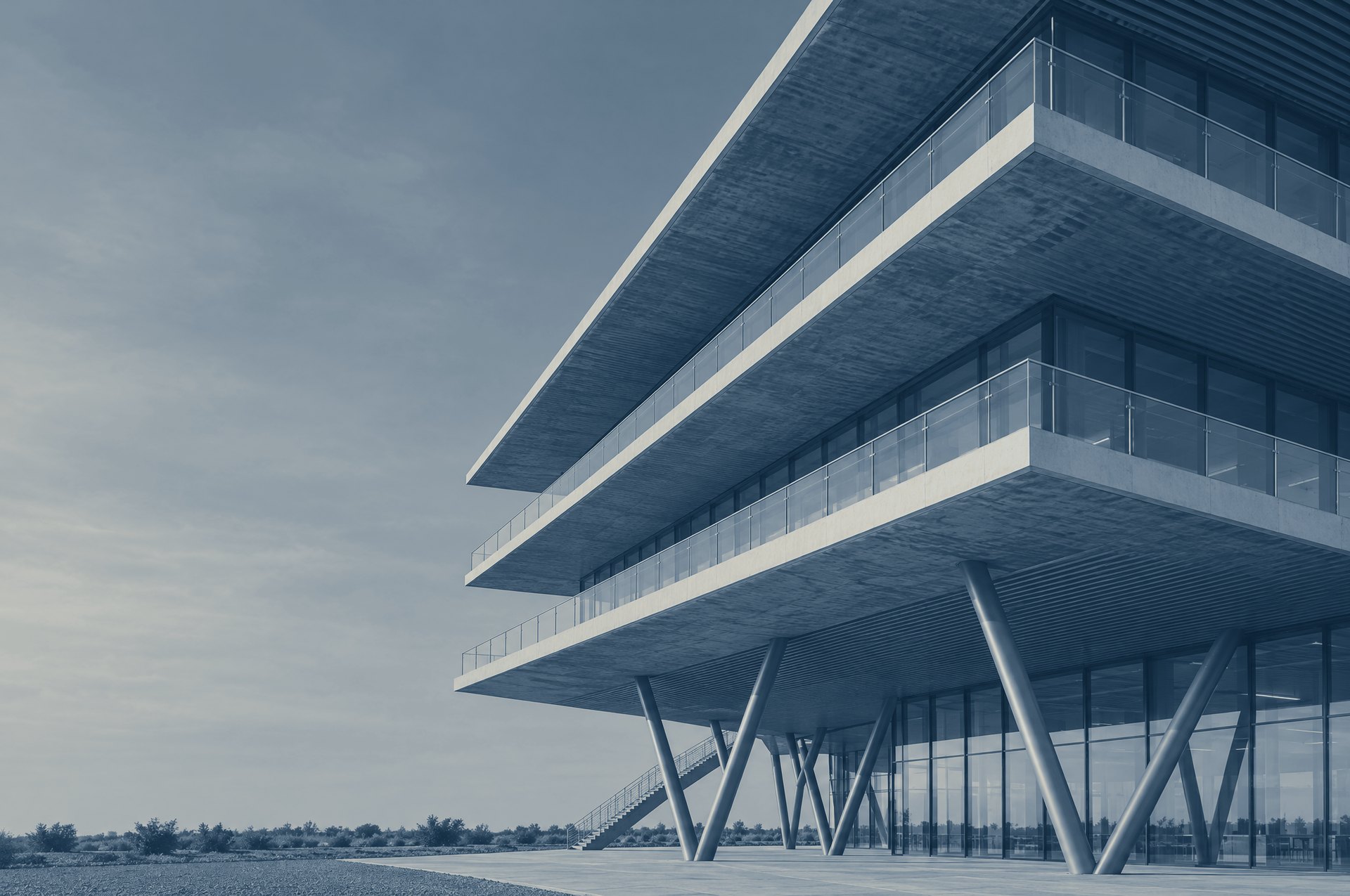 Cantilevered floors of a modern office building resting on slanted columns